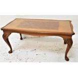WALNUT OCCASIONAL TABLE with an inset glass top, standing on cabriole supports, 96cm wide