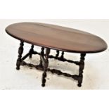 STAINED OAK GATE LEG OCCASIONAL TABLE with shaped drop flaps, standing on bobbin turned supports,