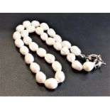 FRESHWATER PEARL NECKLACE with individually knotted pearls and stainless steel clasp.