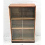 OAK BOOKCASE with a rectangular moulded top above a pair of sliding glass doors with two