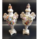 PAIR OF 19th CENTURY MEISSEN URNS the baluster bodies encrusted with flowers, the reserves painted