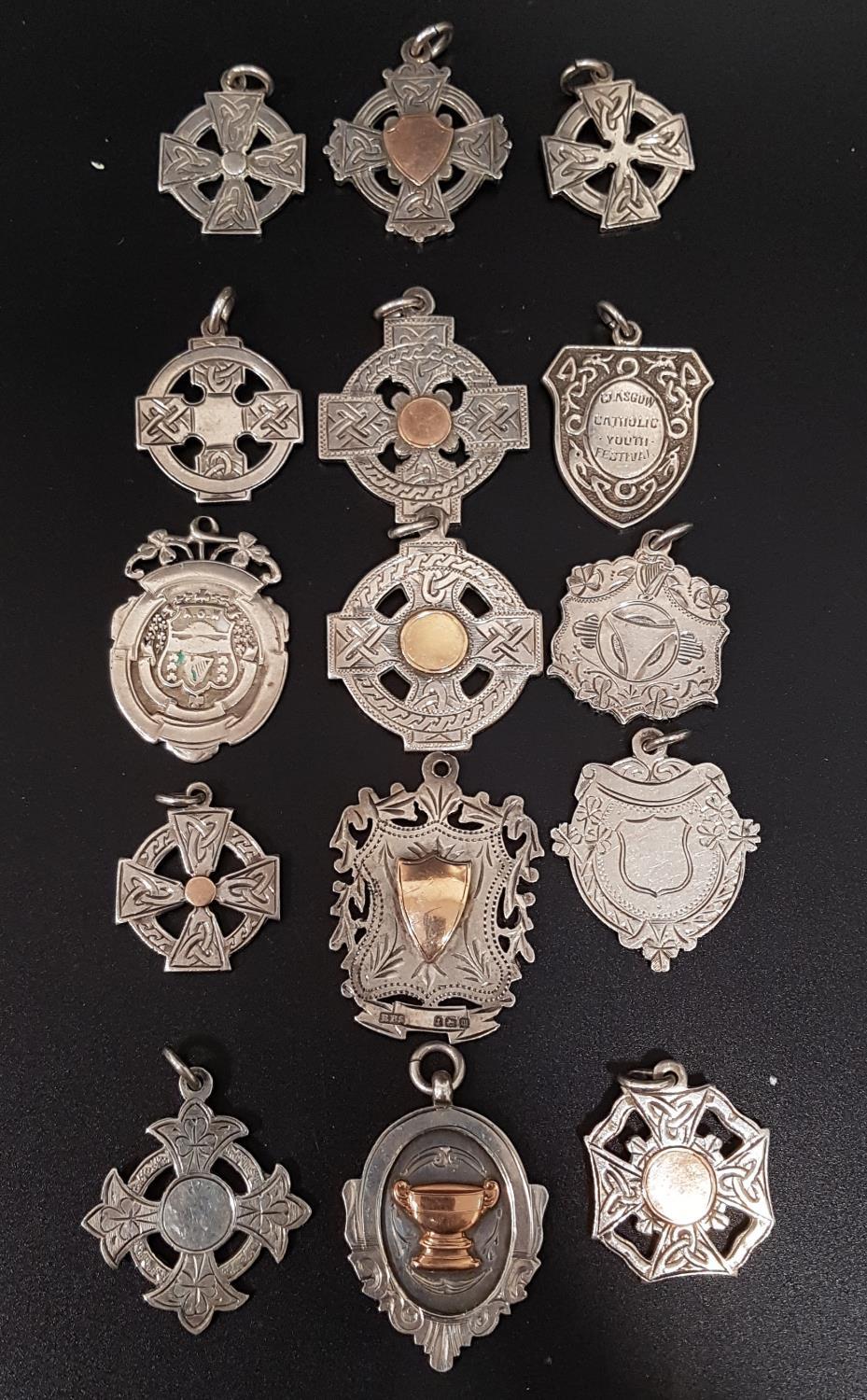 SELECTION OF FIFTEEN SILVER MEDAL FOBS of various designs, some with gold details, ten engraved to