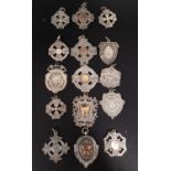 SELECTION OF FIFTEEN SILVER MEDAL FOBS of various designs, some with gold details, ten engraved to