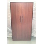 G PLAN TEAK WARDROBE with a pair of doors opening to reveal hanging space, standing on a plinth base