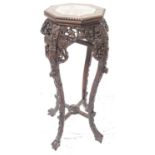 CHINESE HARDWOOD JARDINERE STAND with an octagonal inset red veined marble top above a carved