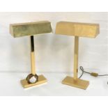 TWO BRASS TABLE LIGHTS with oblong shaped hoods raised on a square column and oblong base, 50cm high