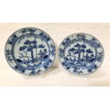 TWO CHINESE CHARGERS both decorated in blue and white with a floral border around a central tree,