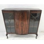 MAHOGANY BOW FRONT DISPAY CABINET with a moulded top above a central panelled door flanked by a pair