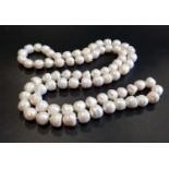 LONG FRESHWATER BAROQUE PEARL NECKLACE with individually knotted pearls, approximately 92cm long