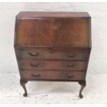 MAHOGANY BUREAU with an inset fall flap and fitted interior above three long graduated drawers,