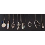 EIGHT SILVER PENDANT ON CHAINS including two with mother of pearl, an Art Nouveau style pendant with