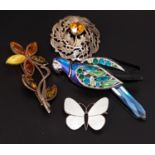 FOUR SILVER BROOCHES comprising a Norwegian white enamel decorated butterfly, 2.8cm wide; a Scottish