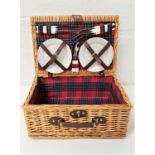 WICKER PICNIC HAMPER with a tartan lined interior and four place settings, comprising plates and