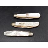 THREE GEORGE V SILVER BLADE AND MOTHER OF PEARL FRUIT KNIVES Sheffield hallmarks for 1919, 1928