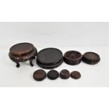 EIGHT HARDWOOD EAST ASIAN STANDS all of circular form and some with pierced and carved decoration (