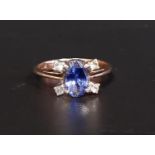 SAPPHIRE AND DIAMOND CLUSTER RING the central oval cut sapphire with two diamonds set at diagonal