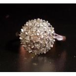 DIAMOND CLUSTER RING the multi diamonds tn circular stepped setting, on eighteen carat gold shank,