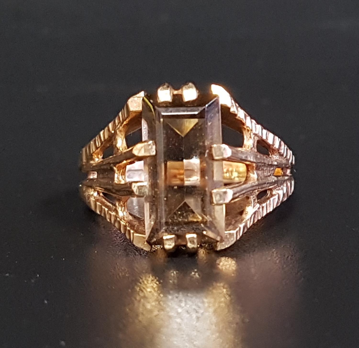 SMOKY QUARTZ SINGLE STONE RING the step cut quartz on nine carat gold shank, with textured and split