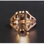 SMOKY QUARTZ SINGLE STONE RING the step cut quartz on nine carat gold shank, with textured and split