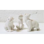 THREE NAO PORCELAIN FIGURINES OF POLAR BEAR CUBS two seated, 6cm and 7.5cm high, and the other on