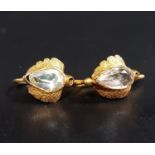 PAIR OF GEM SET EARRINGS possibly aquamarine, in unmarked gold settings with textured detail, with