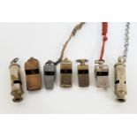 SEVEN VINTAGE WHISTLES comprising a military example marked J. Hudson & Co. Birmingham and dated