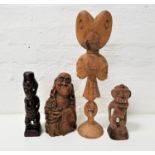 FOUR CARVED WOODEN FIGURES comprising a Maori figure with mother of pearl eyes, 28cm high; an East