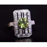 ART DECO STYLE PERIDOT AND DIAMOND PLAQUE RING the central round cut peridot approximately 1ct in