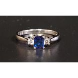 FINE SAPPHIRE AND DIAMOND RING the emerald cut sapphire approximately 0.4cts flanked by diamonds