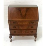 WALNUT BUREAU the fall flap opening to reveal a fitted interior, above three long drawers,