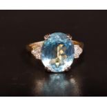 BLUE TOPAZ AND DIAMOND RING the central oval cut topaz approximately 4.2cts, flanked by three