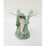 DOLPHIN OCCASIONAL TABLE with a circular glass top above a base of a resin dolphin jumping through