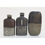 THREE VINTAGE LEATHER AND GLASS HIP FLASKS with removable silver plated/pewter cups, one cup section