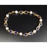 ATTRACTIVE ENAMEL, PEARL AND EIGHTEEN CARAT GOLD BRACELET the blue enamel decorated bow links