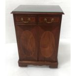 J. SYDNEY SMITH MAHOGANY CABINET with a moulded top above two panelled doors opening to reveal a