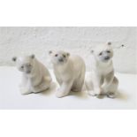 THREE LLADRO PORCELAIN FIGURINES OF POLAR BEARS two seated, 9cm and 12cm high, and the other on