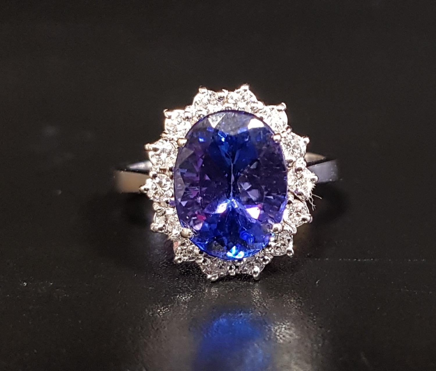 IMPRESSIVE TANZANITE AND DIAMOND CLUSTER RING the large central oval cut tanzanite approximately 4.