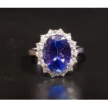 IMPRESSIVE TANZANITE AND DIAMOND CLUSTER RING the large central oval cut tanzanite approximately 4.