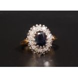 SAPPHIRE AND DIAMOND CLUSTER RING the central oval cut sapphire weighing approximately 1.13cts, in