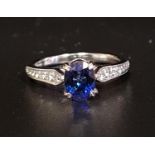 SAPPHIRE AND DIAMOND RING the oval cut sapphire approximately 0.8cts flanked by diamond set