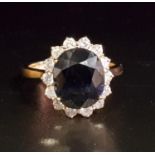 SAPPHIRE AND DIAMOND CLUSTER RING the large central oval cut sapphire approximately 4.65cts, in