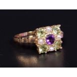 UNUSUAL 'SUFFRAGETTE' RING the central amethyst in peridot and pearl square shaped surround