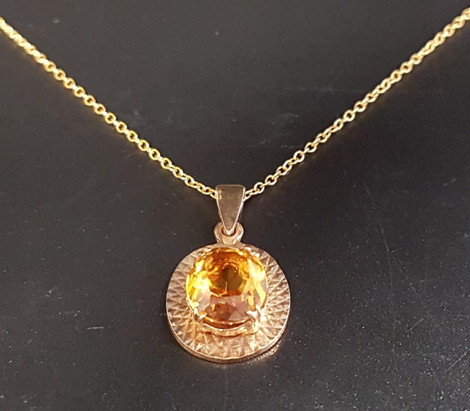 CITRINE SINGLE STONE PENDANT the oval cut citrine in nine carat gold mount and on nine carat gold