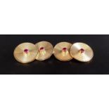 PAIR OF RUBY SET NINE CARAT GOLD CUFFLINKS each of the circular faces with engraved concentric