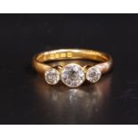 GRADUATED DIAMOND THREE STONE RING the bezel set diamonds totaling approximately 0.9cts, on twenty-