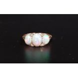 PRETTY OPAL AND DIAMOND RING the three graduated oval cabochon opals with small diamonds between, on
