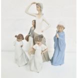 FOUR NAO FIGURINES one a mother and daughter, 36.5cm high, a young girl with her hands together as