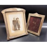 TWO GEORGE V SILVER PHOTOGRAPH FRAMES one with floral embossed detail, Chester 1917, 18.2cm high;
