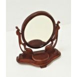 VICTORIAN MAHOGANY DRESSING TABLE MIRROR with an oval plate on shaped carved supports, above a