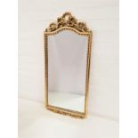 GILT FRAME OBLONG WALL MIRROR surmounted by gilt bow decoration, 84.5cm high